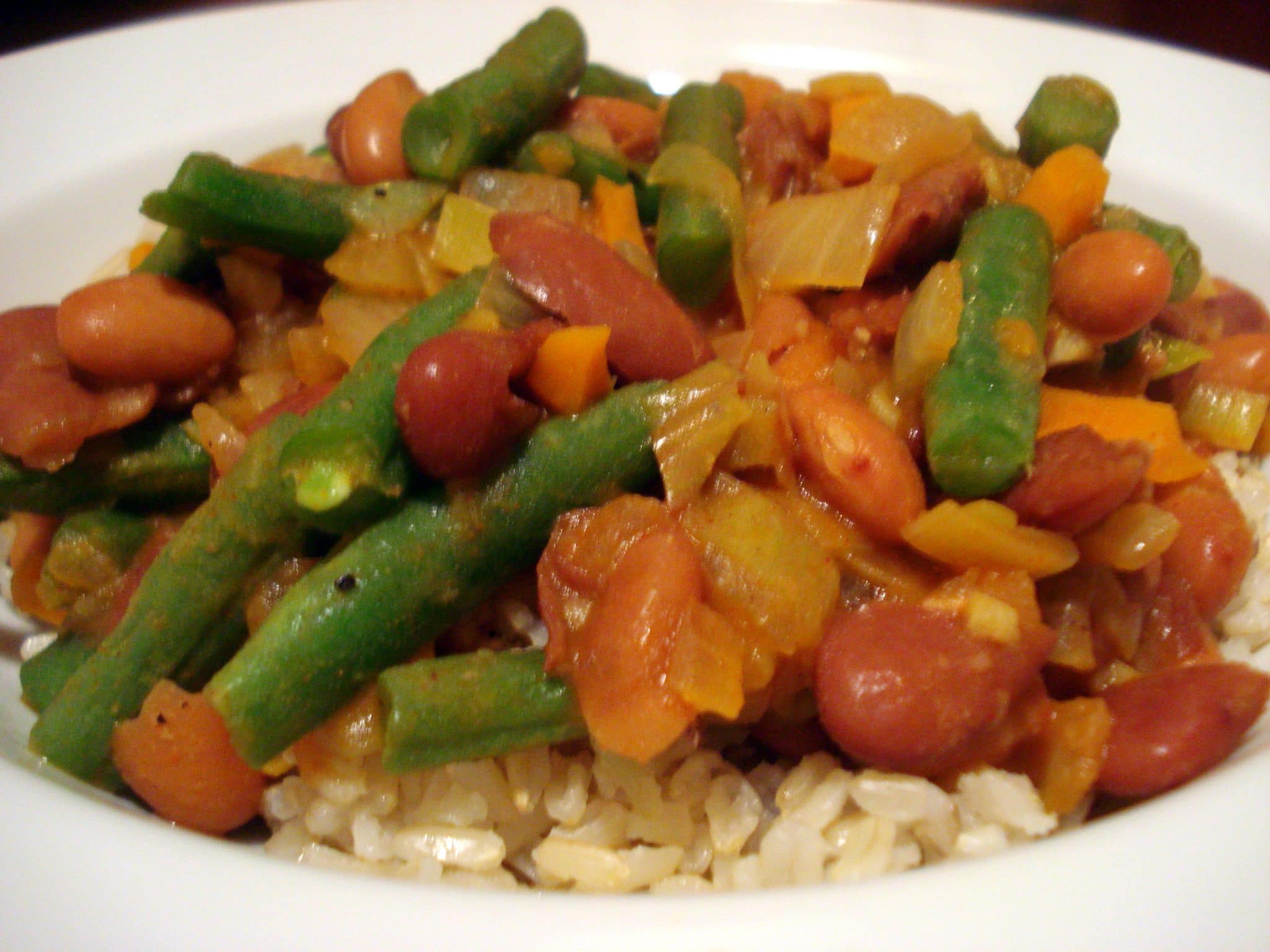 Bean stew with green beans and onions over rice